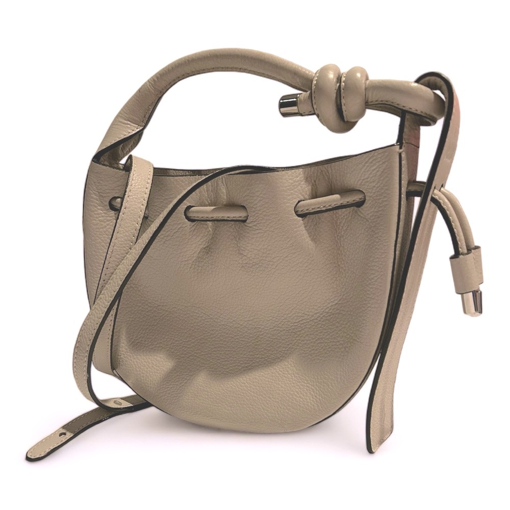 Behno crossbody bag with drawstring top. 7” W x 8” H x 2” D. Handle drop 5.5”.
